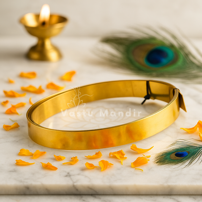 Pure brass Vastu strip coil on a branded plate with diya, petals and peacock feather