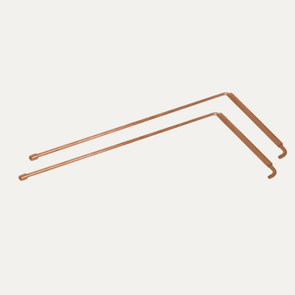 Angled copper L-rods shown together on a light neutral background