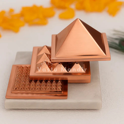 Three-layer copper pyramid displayed front-facing in a stepped arrangement on a white platform