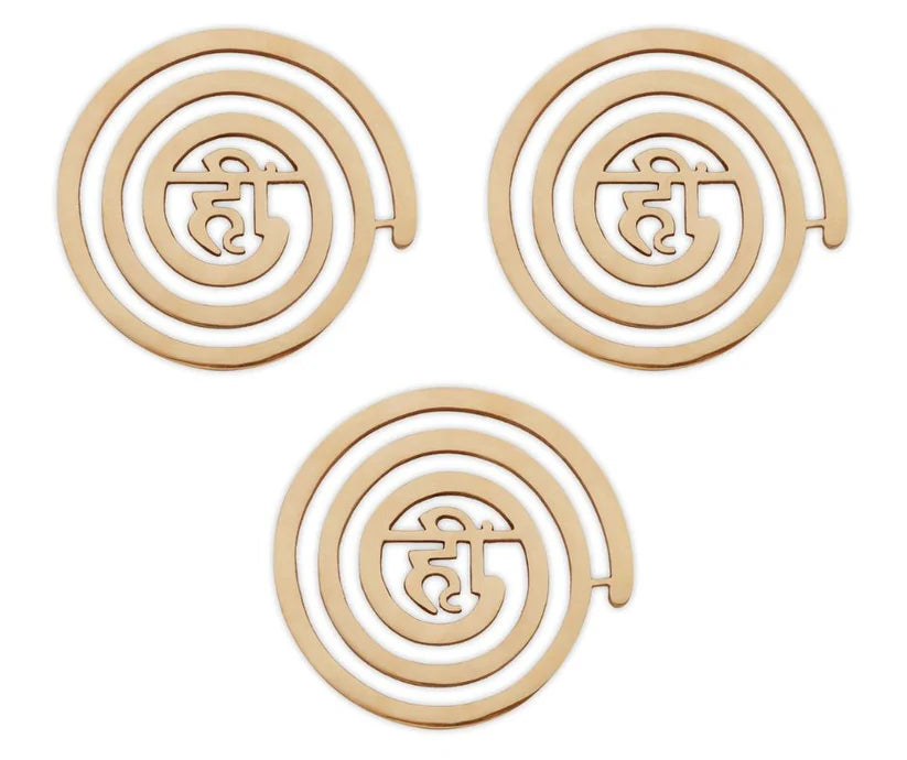 Three brass Hii spiral helixes arranged together on a white background