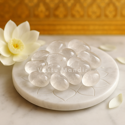 Clear quartz stones arranged on a carved plate with lotus flower and brass decor
