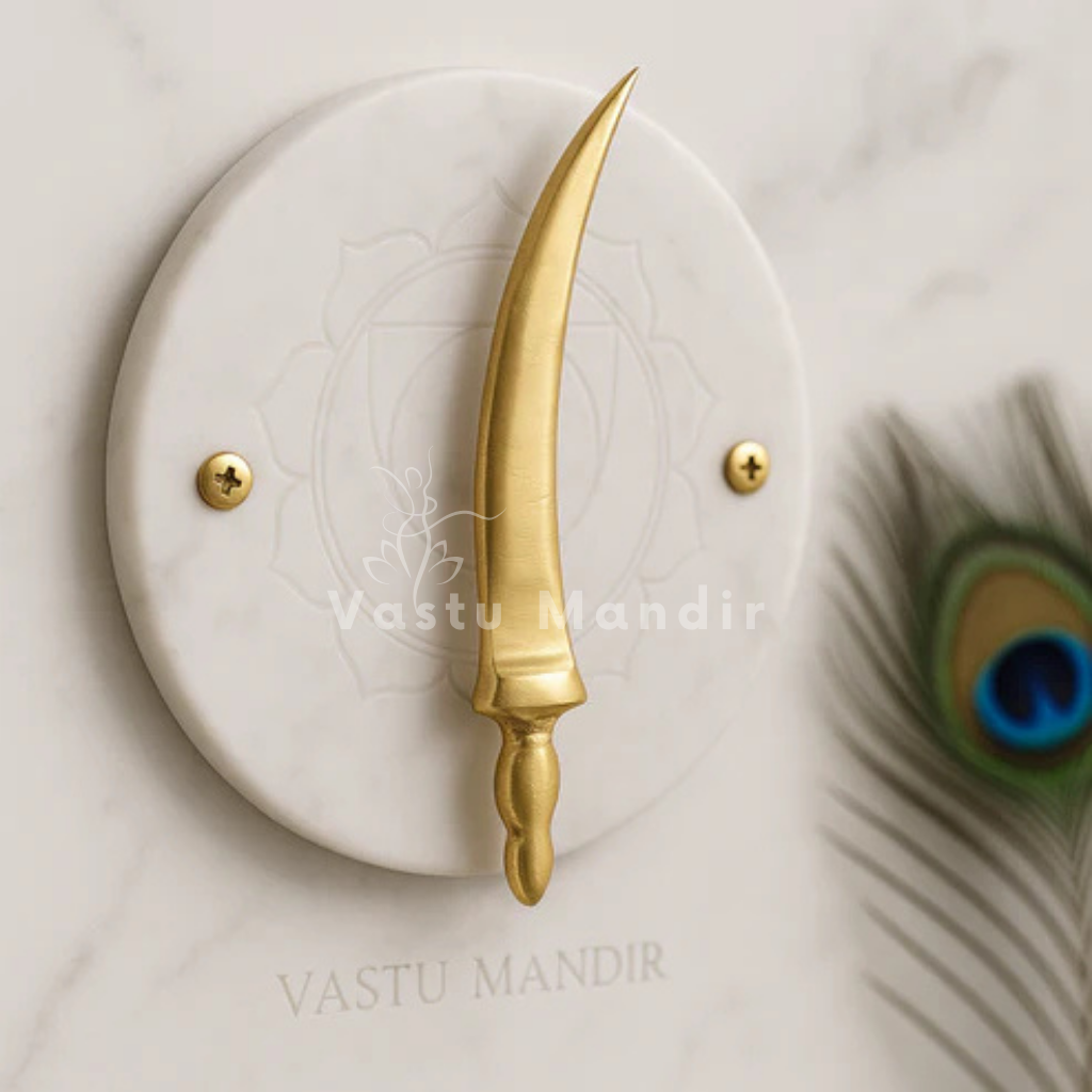 Curved brass talwar miniature on a white marble disc with peacock feather accents