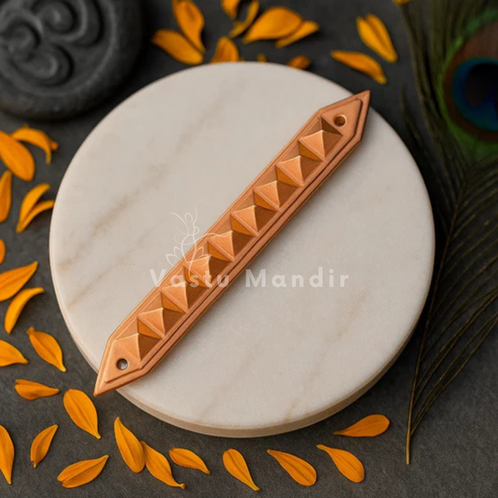 Copper Pyramid Strip on a marble surface with orange leaves and peacock feathers.