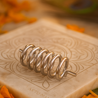 Aluminium Vastu spring displayed on an engraved stone surface