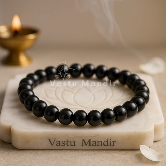 Classic black tourmaline crystal bracelet shown with a hand in a lifestyle photograph