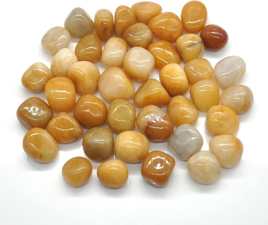 Pile of small golden yellow jade stones isolated on a clean white background