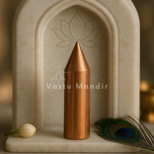 Copper Vastu Kilak rod displayed upright in a softly lit arched niche