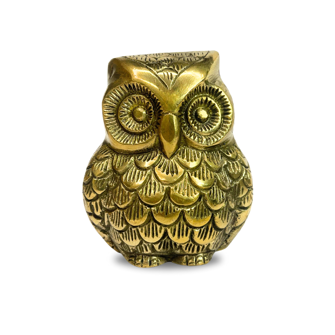 Brass owl idol front-left view isolated on white background