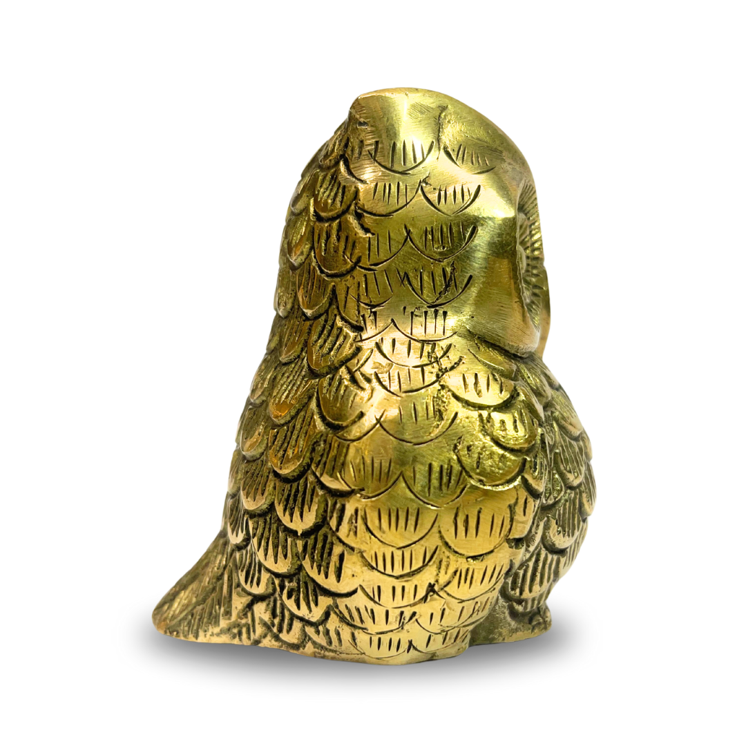 Brass owl idol rear three-quarter view showing wing and feather texture