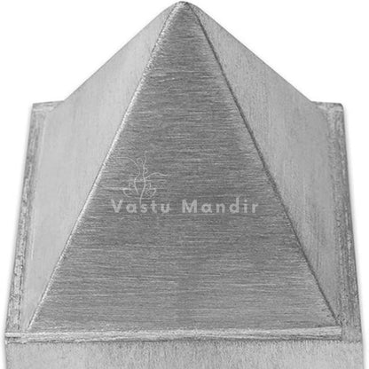Close-up of brushed zinc surface and front face on the solid metal pyramid