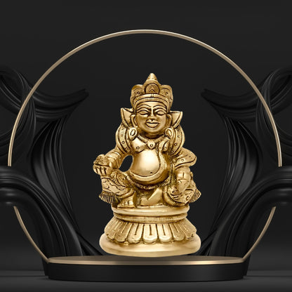 Brass Kuber Ji idol displayed against a black-and-gold decorative backdrop