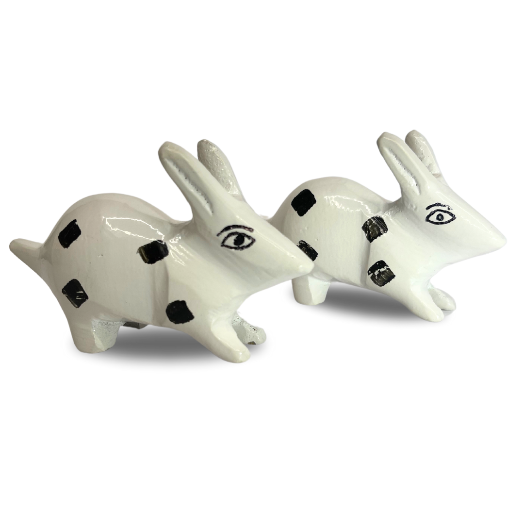 White enamel rabbit pair pair arranged nose-to-nose on white background