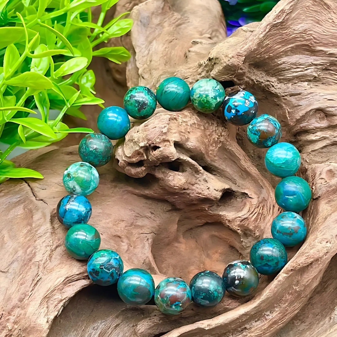 Chrysocolla crystal bracelet presented with a hand for visual scale