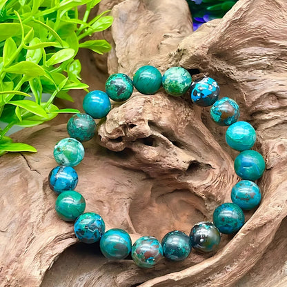 Chrysocolla crystal bracelet presented with a hand for visual scale