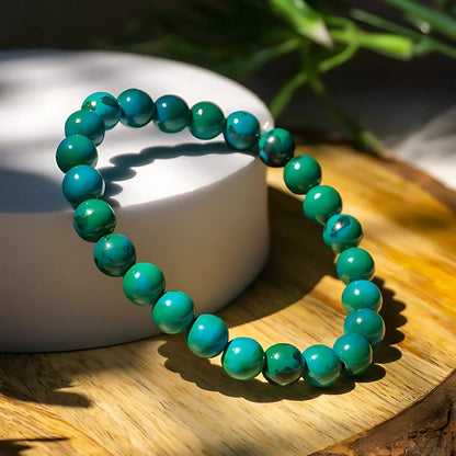 Chrysocolla crystal bracelet shown in a separate hand-held product photograph