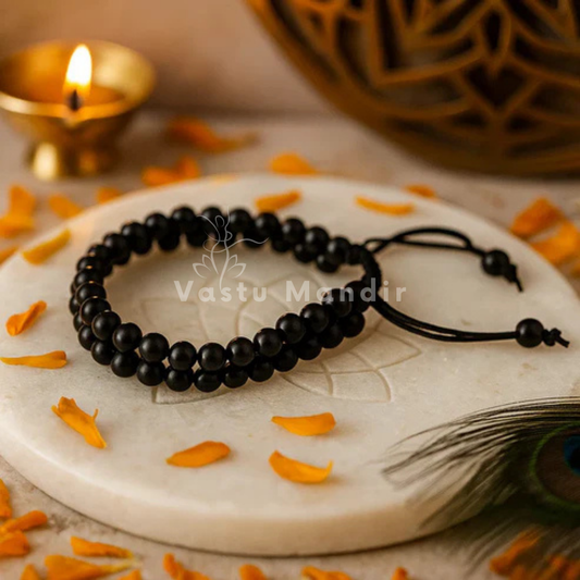 Natural black tourmaline dual strand bracelet shown with a hand in a lifestyle photograph