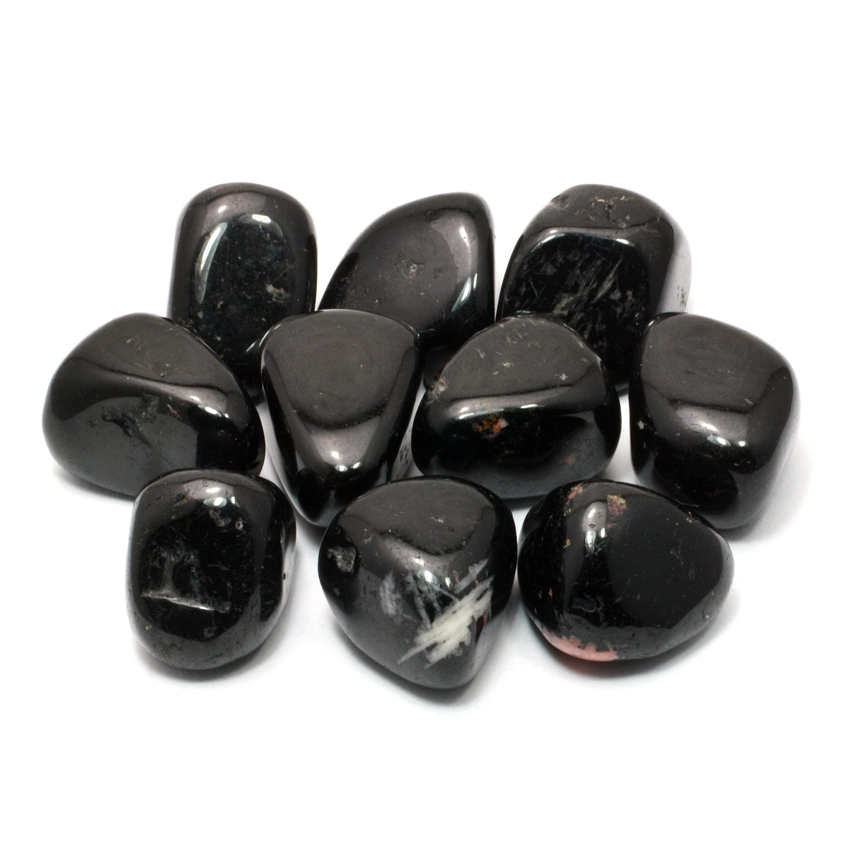 Small group of polished black tourmaline stones isolated on a clean white background
