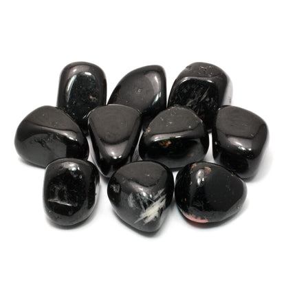 Small group of polished black tourmaline stones isolated on a clean white background