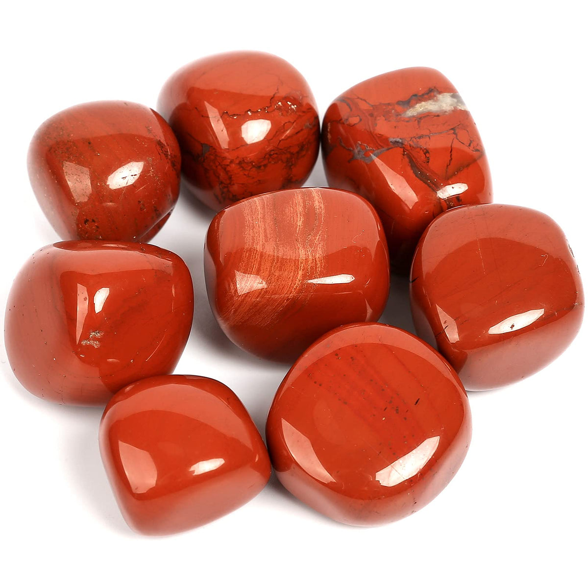 Large polished red jasper stones grouped on a clean white background