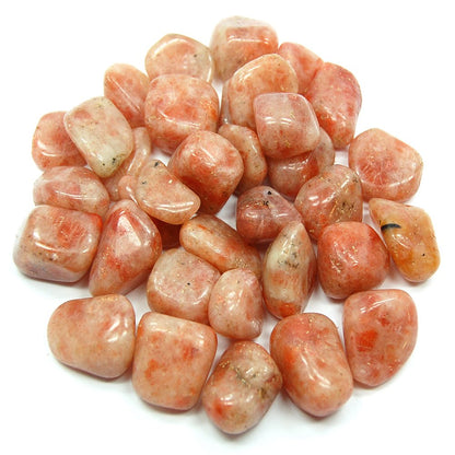 Pile of sunstone tumbled stones on a clean white background