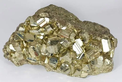 Pale metallic pyrite cluster isolated on a clean white background