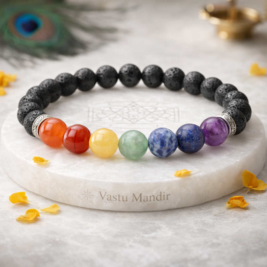 7 Chakra and Lava Stone Bracelet on a marble surface with 'Vastu Mandir' branding.
