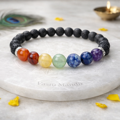 7 Chakra and Lava Stone Bracelet on a marble surface with 'Vasu Mandir' branding.