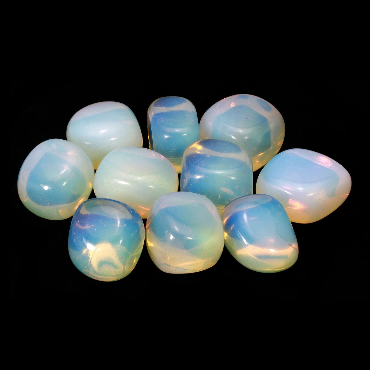 Group of rounded opalite stones arranged against a black background