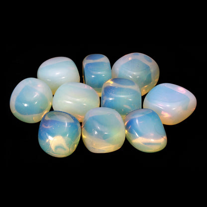 Group of rounded opalite stones arranged against a black background