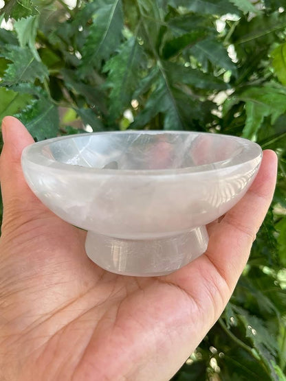 Ice cream selenite charging bowl shown held in a hand for scale