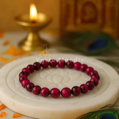 Natural pink tiger eye crystal bracelet shown in a second hand-held product view