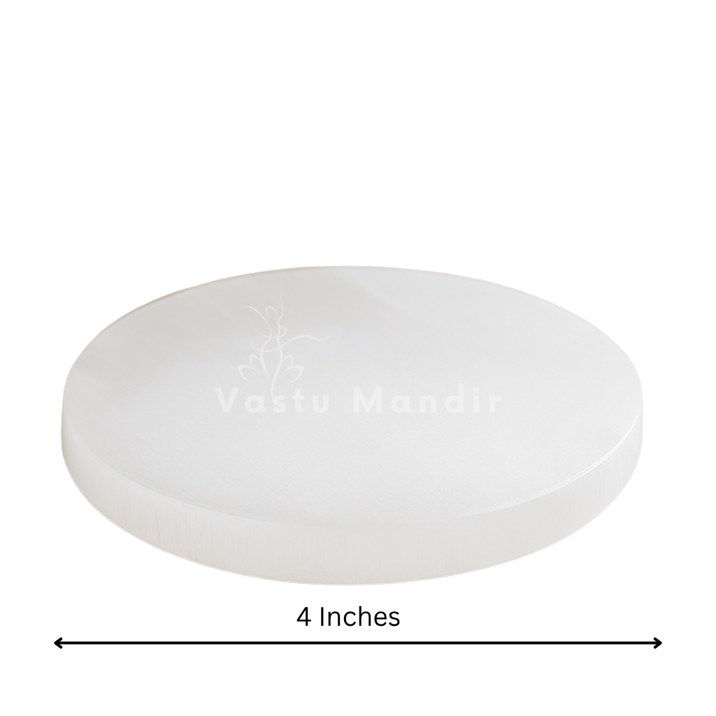 Plain round selenite plate in a close product view on white