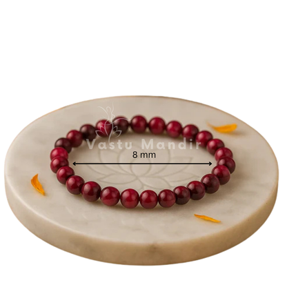 Natural pink tiger eye crystal bracelet presented with a hand for visual scale