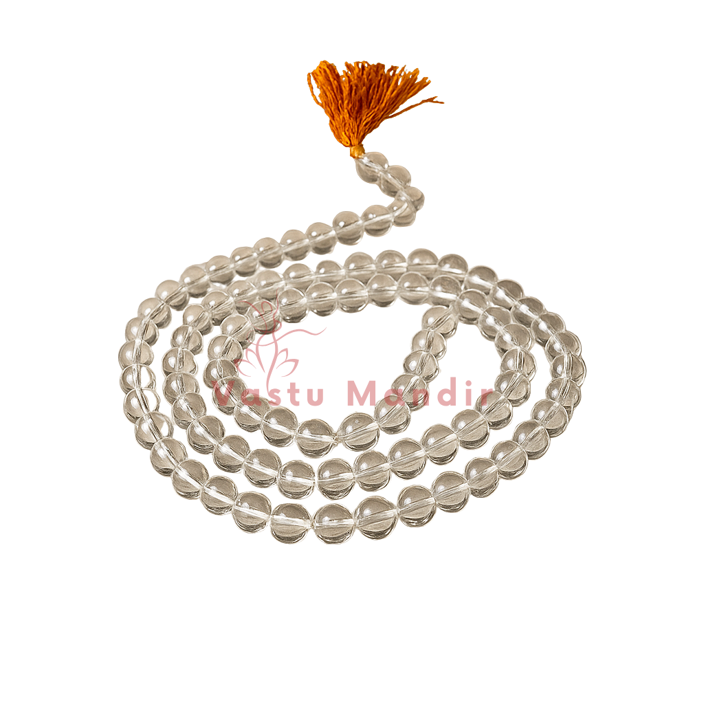 Coiled clear sphatik crystal mala with an orange tassel isolated on a white background