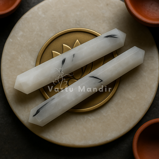 Black rutile crystal pencil displayed in a dark, softly lit spiritual setting
