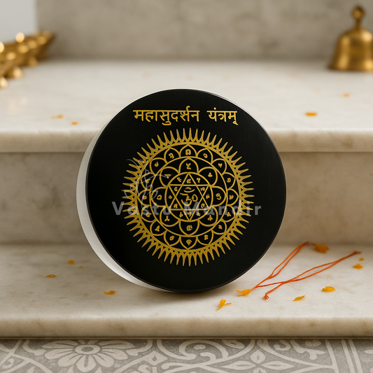 Mahasudarshan yantra selenite plate shown held in a hand for scale