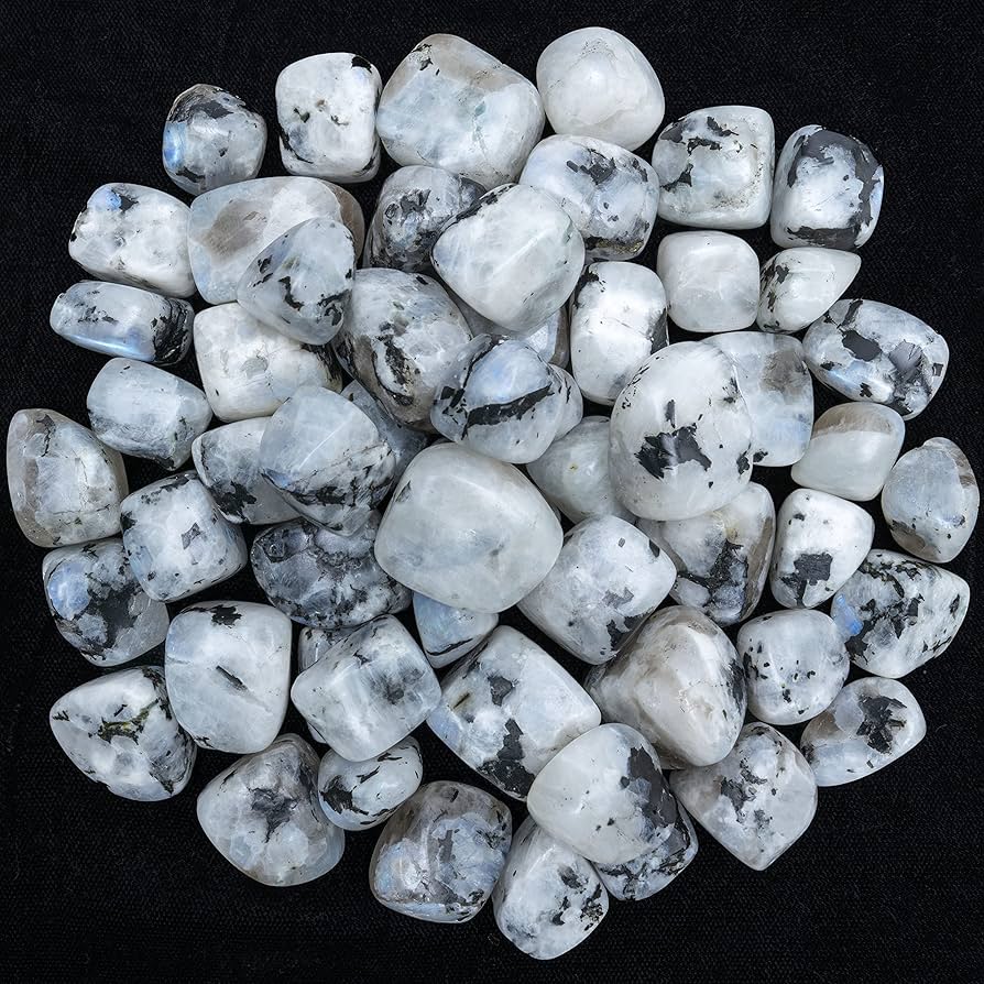 Rainbow moonstone pieces arranged against a dark background for a close product view