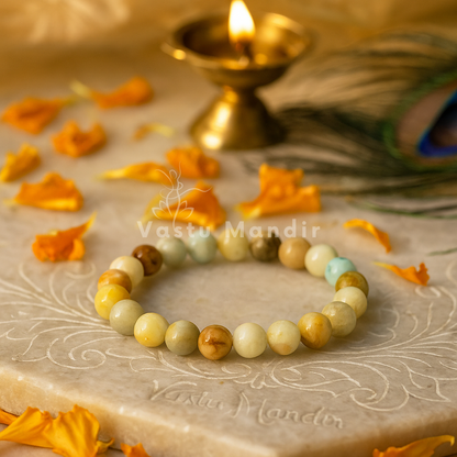 Natural Amazonite Mixed Crystal Bracelet on a decorative surface with floral petals and a lit candle.