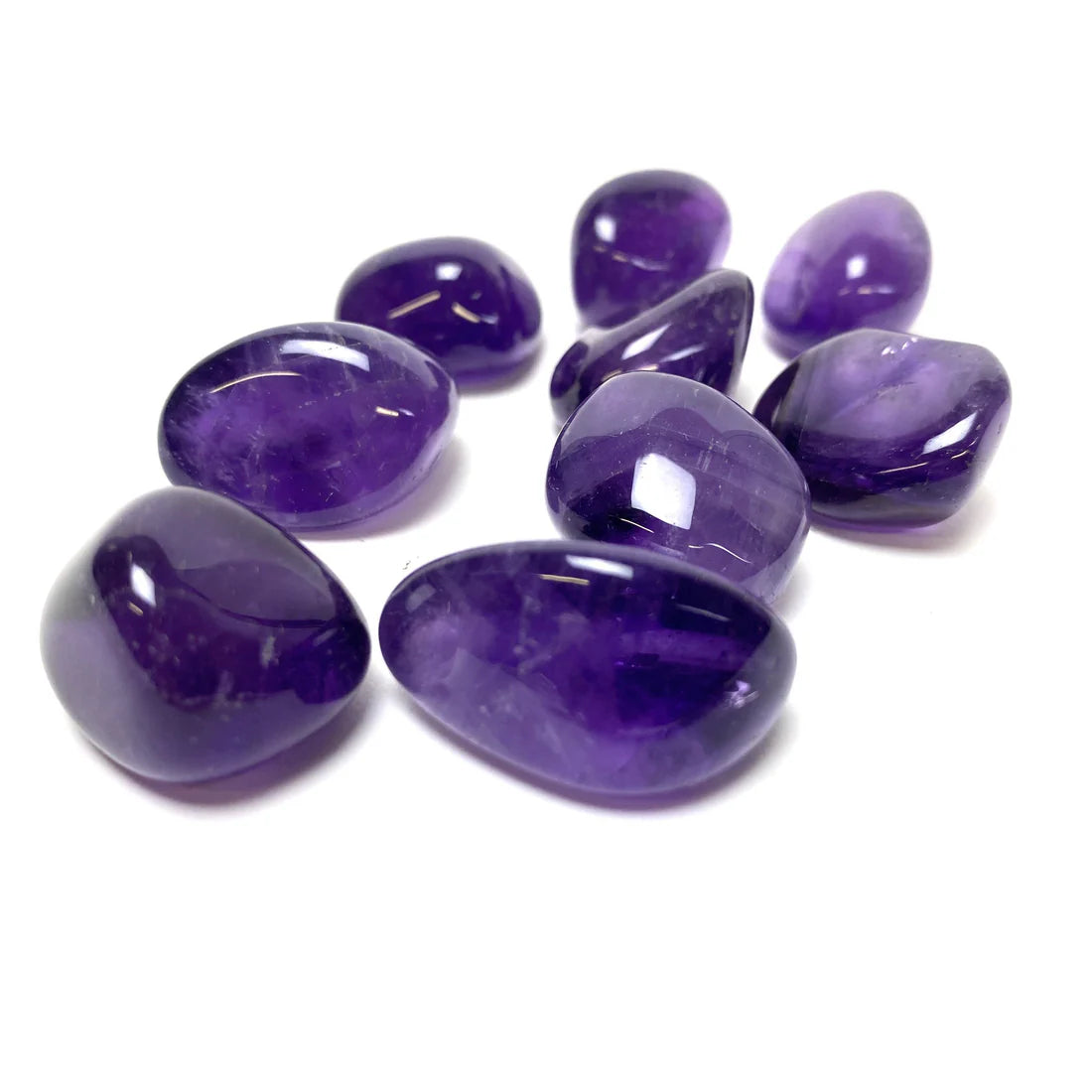 Small group of deep purple amethyst stones isolated on a clean white background