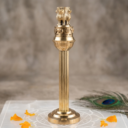 Brass Ashoka Pillar idol standing on a marble slab with floral accents