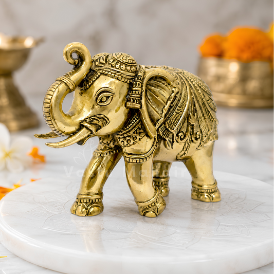 4-inch royal brass elephant figurine front three-quarter view on a sacred white platform