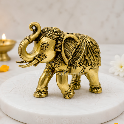 4-inch royal brass elephant figurine on a white pedestal with a softly blurred background
