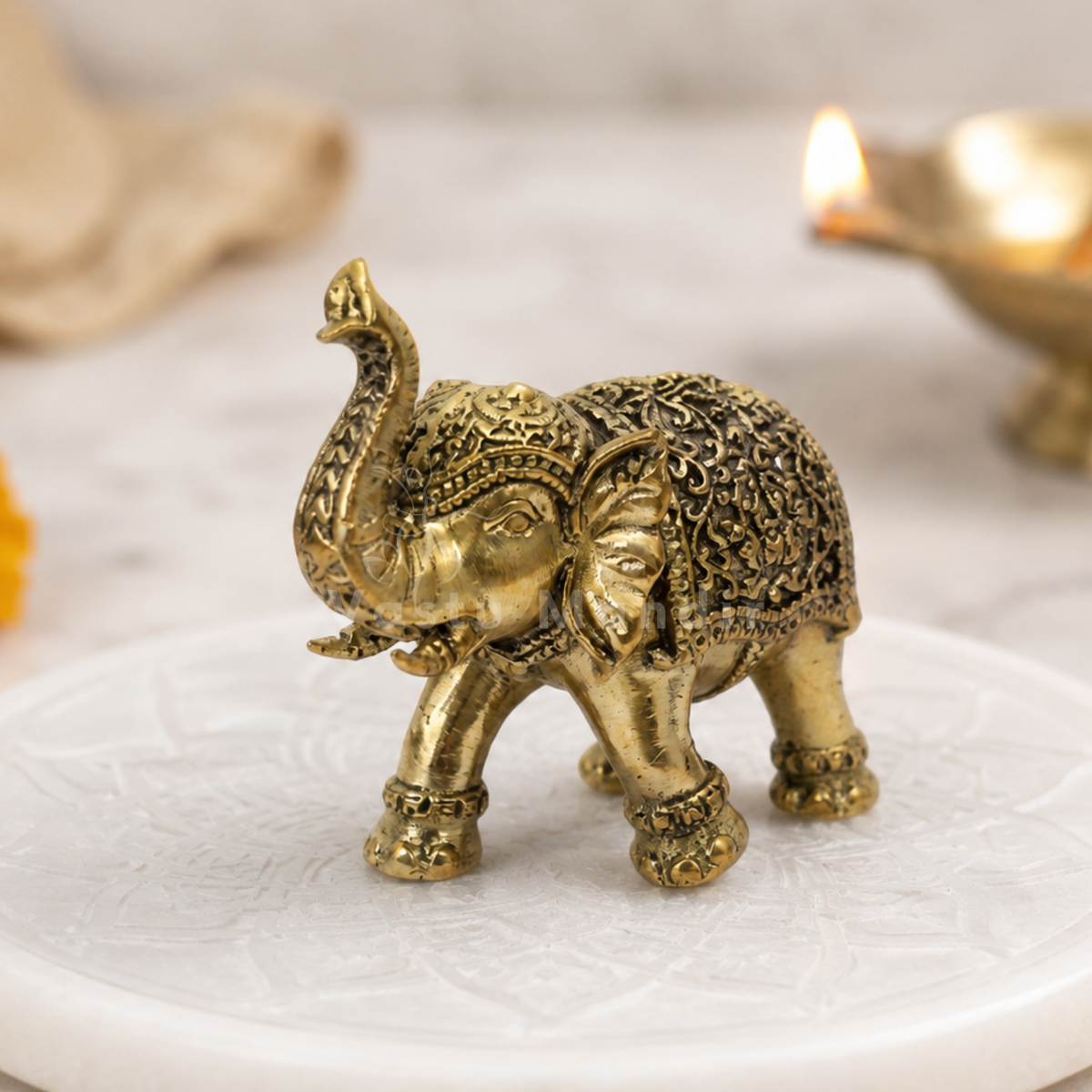 2-inch royal brass elephant figurine alternate front angle on a sacred white platform
