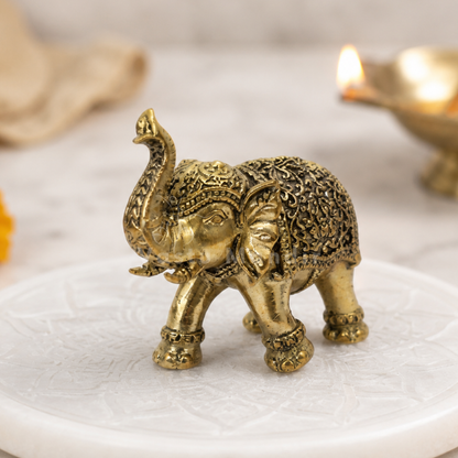 2-inch royal brass elephant figurine alternate front angle on a sacred white platform