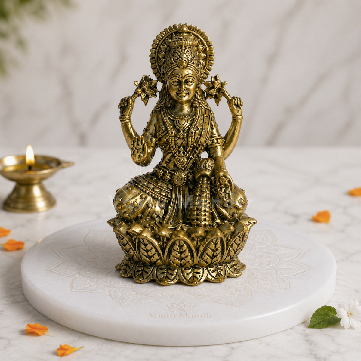 Brass Goddess Lakshmi idol alternate front angle on a styled white platform