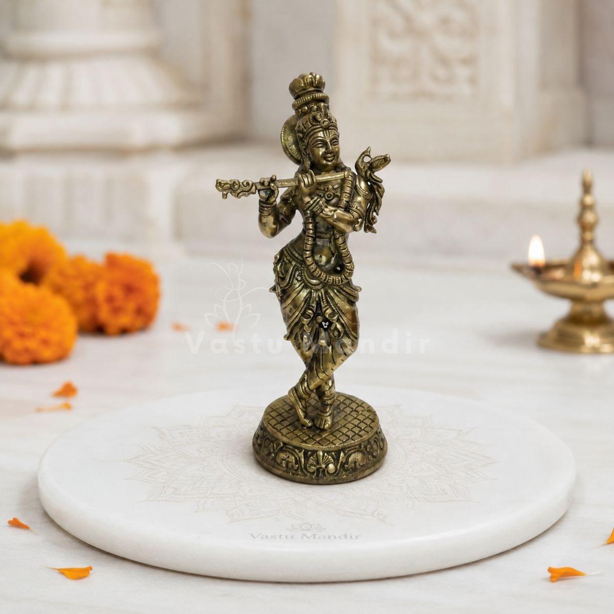Brass Lord Krishna idol alternate front angle on a styled display platform
