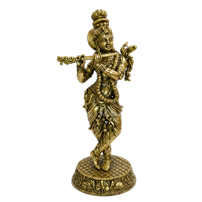Brass Lord Krishna idol displayed on a decorative shelf in a neutral interior