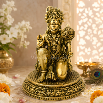 Hanuman Ji brass idol alternate front angle on a styled white platform