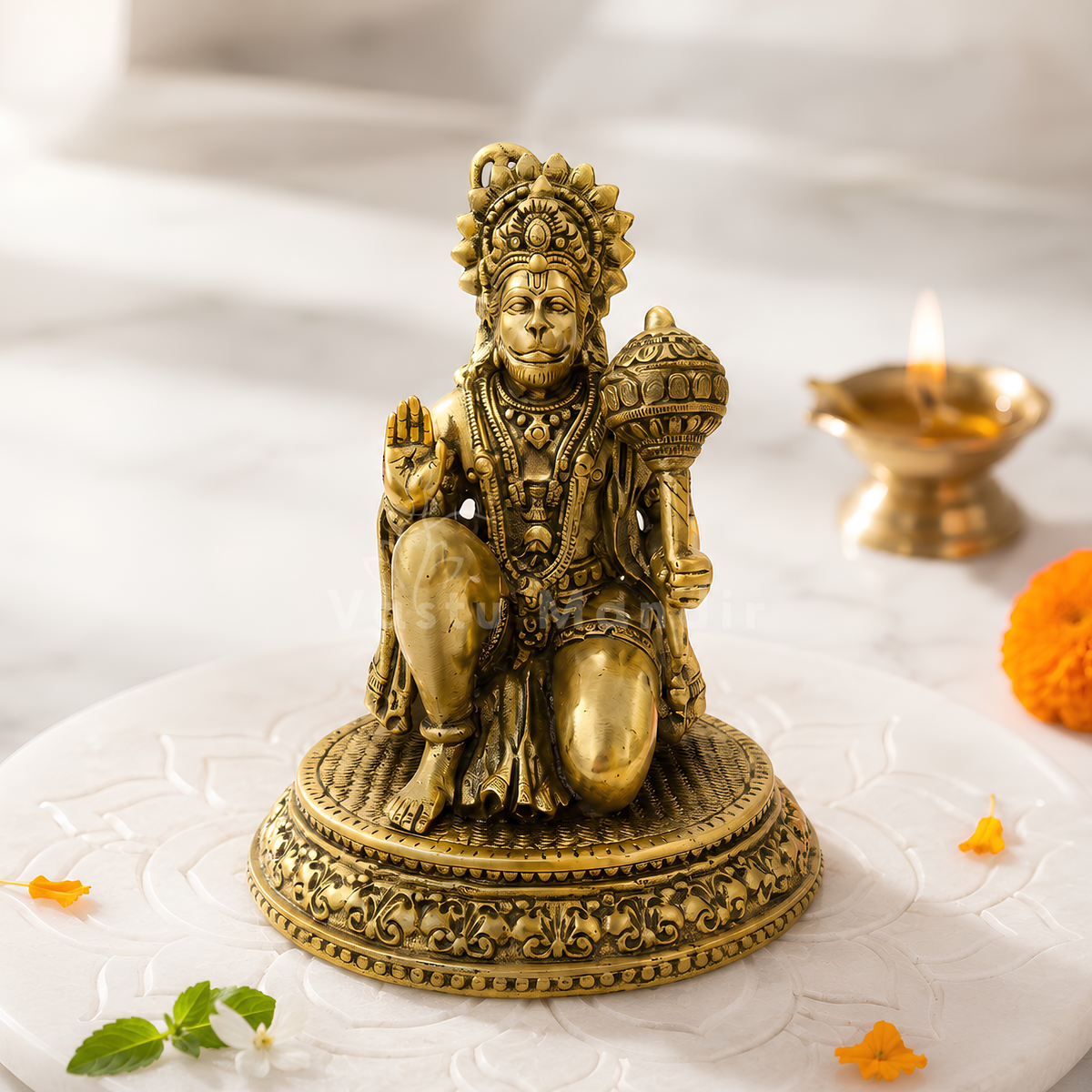 Hanuman Ji brass idol front view on a sacred white pedestal with floral accents