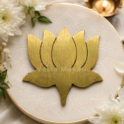 Brass lotus with brushed metallic petals on a white plate with flowers